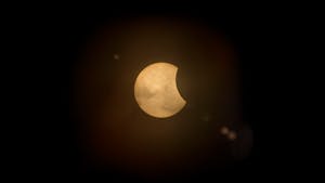 Captured partial solar eclipse set against a deep dark sky, perfect for astronomy enthusiasts.